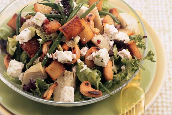 meal salad with baked potatoes, cashew nuts and white cheese