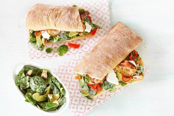 roll with spinach salad and peppadews