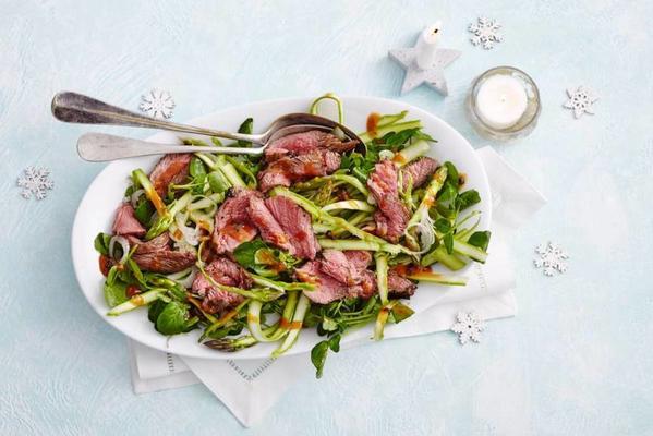 thinly sliced ​​Asian veal fillet on a watercress salad