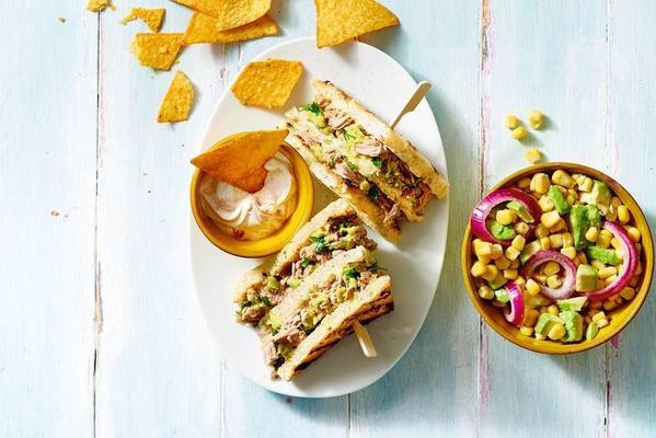 tuna sandwich with guacamole and corn salad