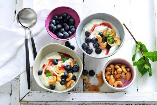 Greek yogurt with cashew nuts, blueberries and strawberry whirl