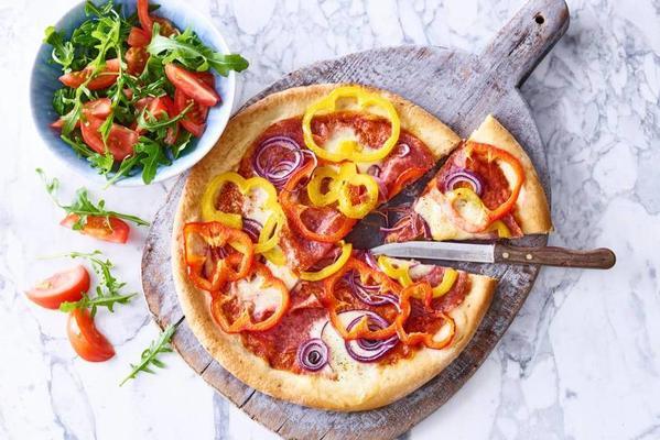 salami pizza with mozzarella and tomato salad