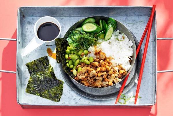 green sushi tray with crispy tofu and nori