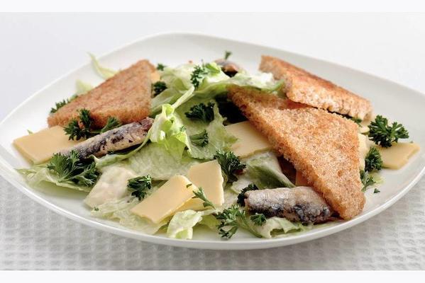 meal salad with sardines and croutons