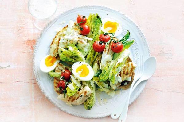 grilled caesar salad with cherry tomatoes and chicken