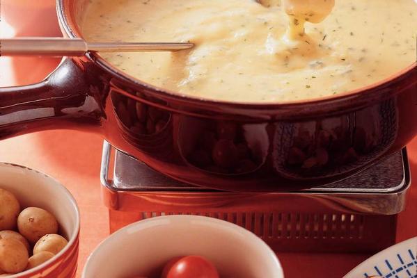 cheese fondue with garden herbs and raw vegetables