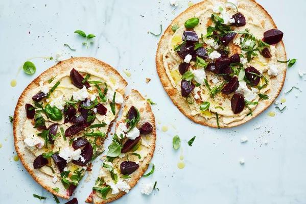 crunchy tortilla with hummus, green herbs and white cheese