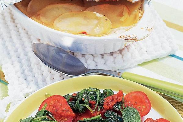 potato dish with white cheese and spinach tomatoes