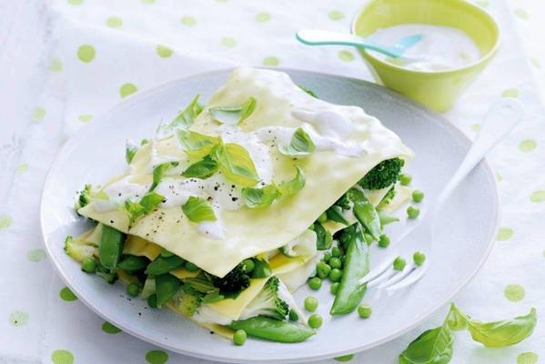 open lasagna with green vegetables