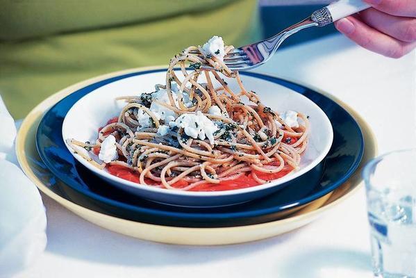 pesto spaghetti with tomato sauce and white cheese