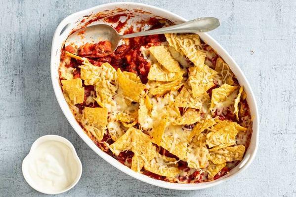 nacho dish with tomato cubes and grated cheese
