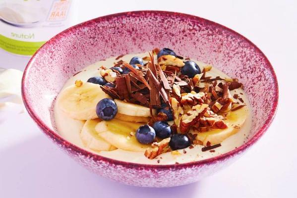 breakfast bowl with fruit, chocolate and nuts