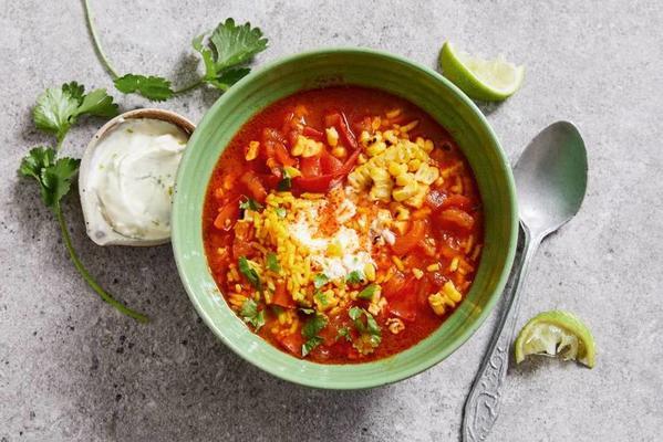 Mexican corn soup with lime cream and yellow rice
