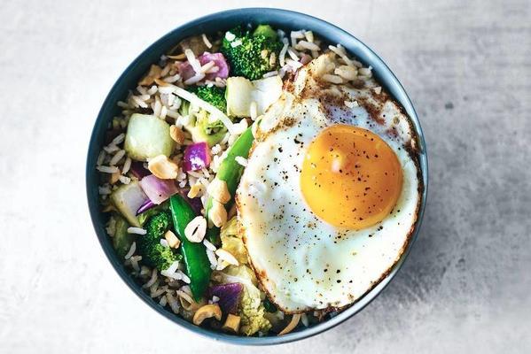 chinese rice dish with broccoli and fried egg