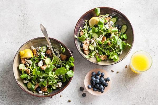 richly filled breakfast salad with wholemeal croutons and blueberries