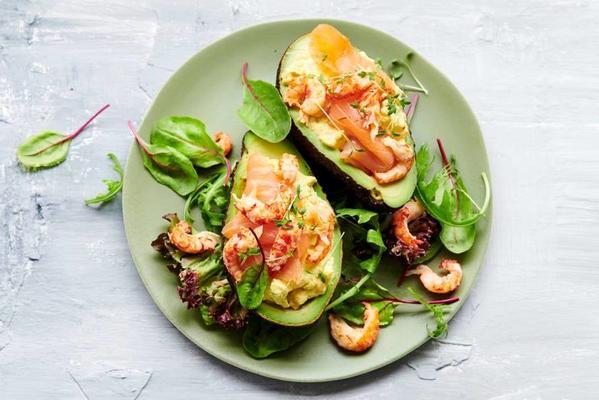 stuffed avocado with egg salad, salmon and crayfish
