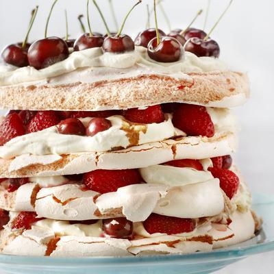 merengue cake with strawberries and cherries