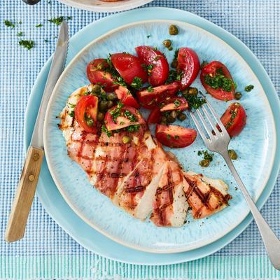 grilled chicken schnitzel with parma ham and tomato salad