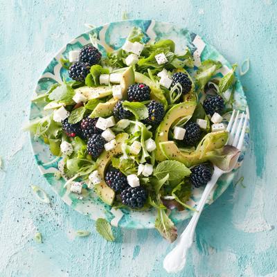 green salad with blackberries, avocado and red fruit dressing