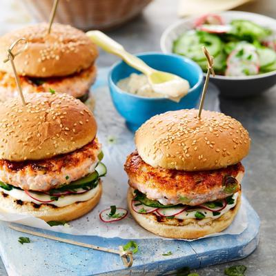 salmon burger with spicy mayo and cucumber salad