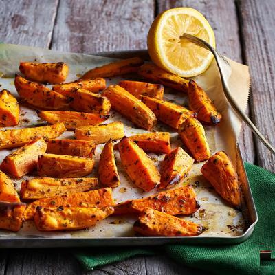 sweet potato wedges from the oven with oregano and lemon