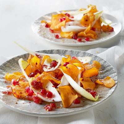 chicory salad with peppery sweet potato chips and pomegranate dressing
