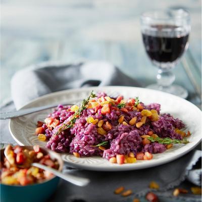 risotto with red cabbage, bacon cubes and pine nuts