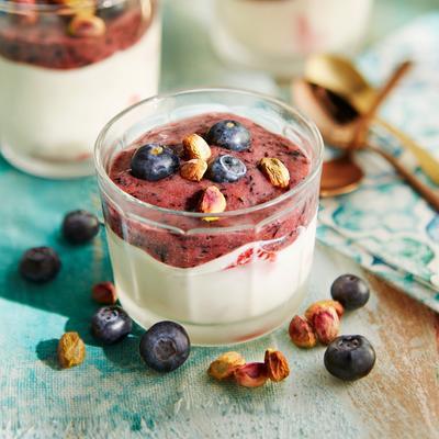 yogurt semifreddo with strawberries, berry sauce and pistachio nuts