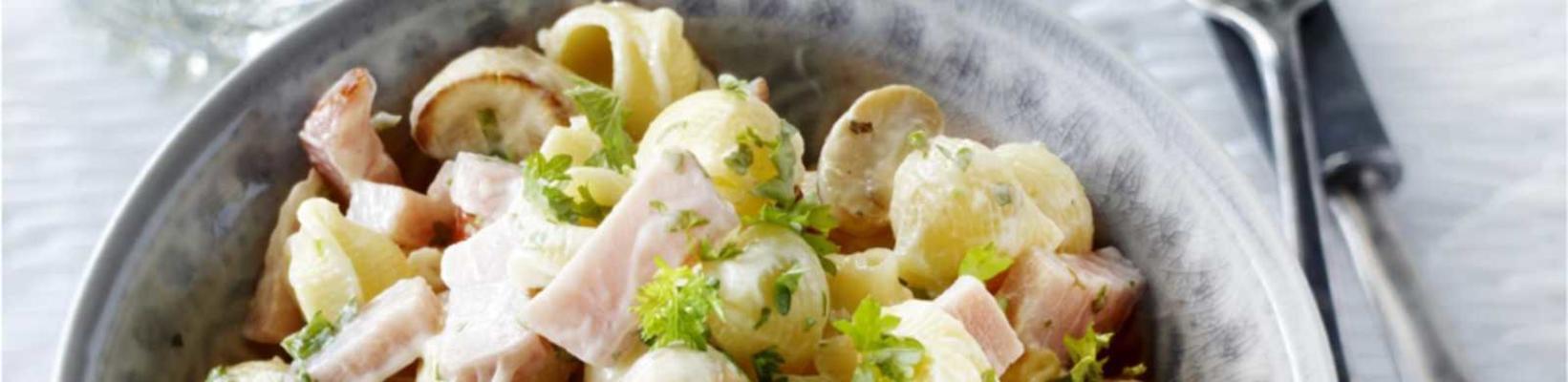 salad of pasta shells with ham and mushrooms