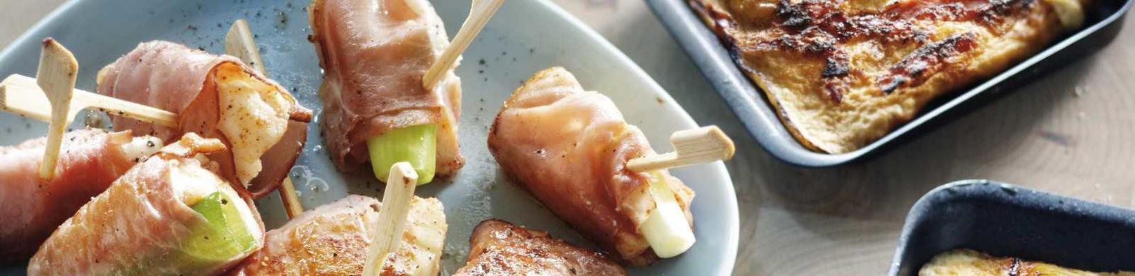 fish skewer with raw ham and spring onion