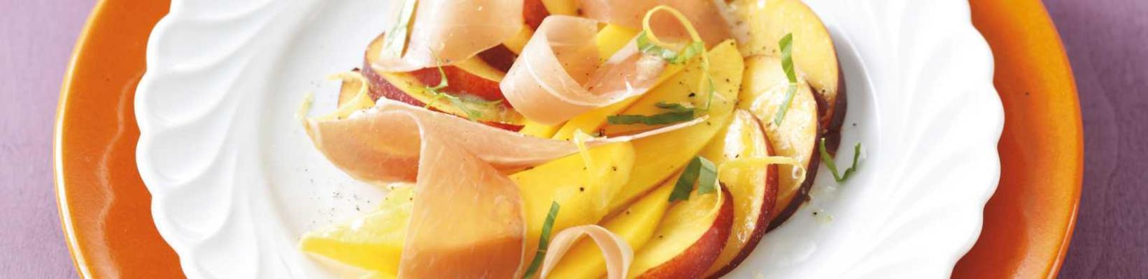 orange fruit salad with parma ham