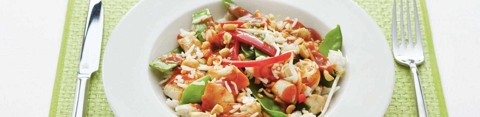 chicken fillet with sweet-sour tomato sauce, snow peas and peanuts