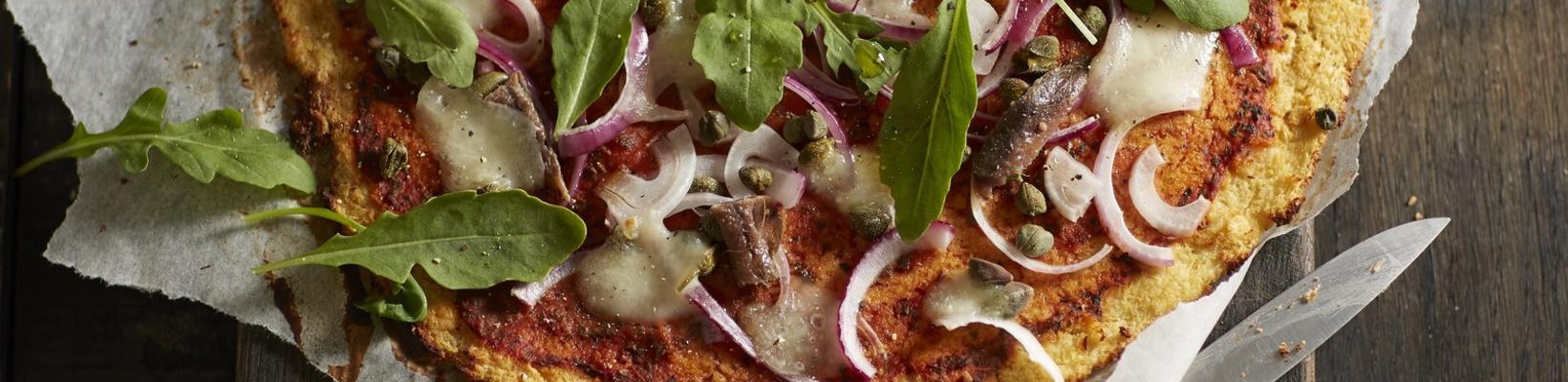 cauliflower pizza with red onion, capers and anchovies