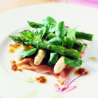 white and green asparagus with raw ham