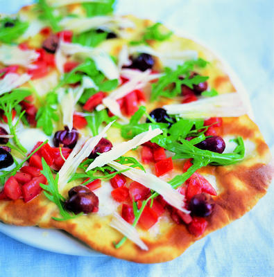 pizza with olive, tomato, arugula, parmesan and mozzarella