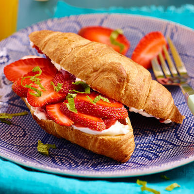 croissant with strawberries and orange juice