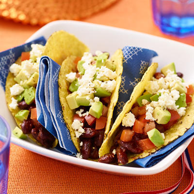 tacos with spicy chili beans, avocado and feta