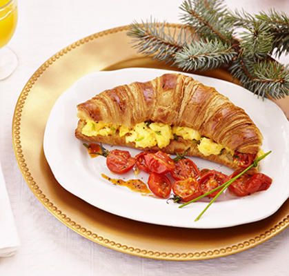 croissant with cheese-scrambled eggs and baked tomatoes