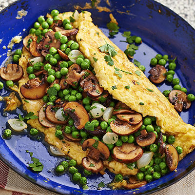 farmer's omelet filled with peas and mushrooms