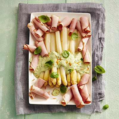 white asparagus with green basil sauce and ham