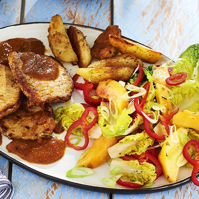pork fillets with peach sauce and salad