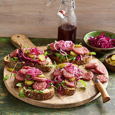 bruschetta with beef sausage and marinated red cabbage and onion
