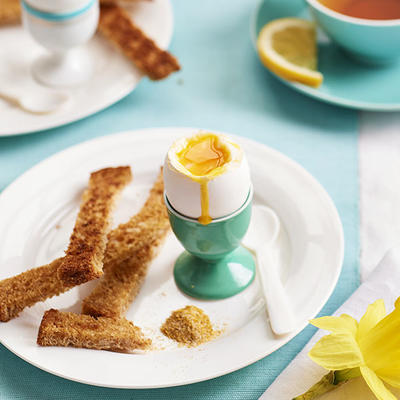 soft-boiled egg with bread rolls and curry salt