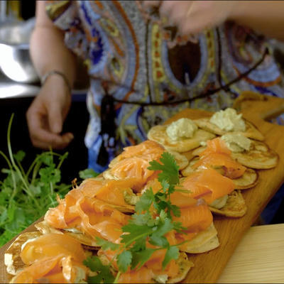 blini pie with salmon and green herbs