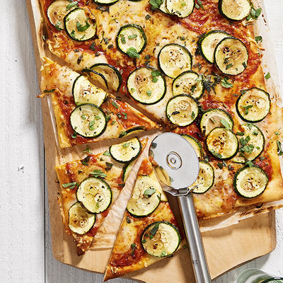 summery plate pizza with zucchini and tomato