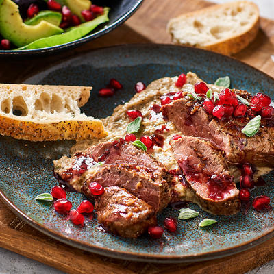 steak with eggplant puree and pomegranate seeds