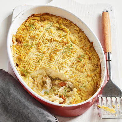 casserole with mashed potatoes, fish and vegetables in creamy sauce