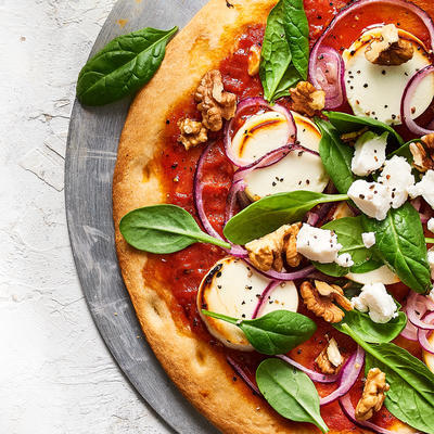 cauliflower pizza with vegetables and goat cheese