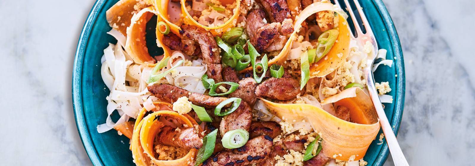Thai noodles with pig strips and carrot ribbons Thai noodles with pig strips and carrot ribbons